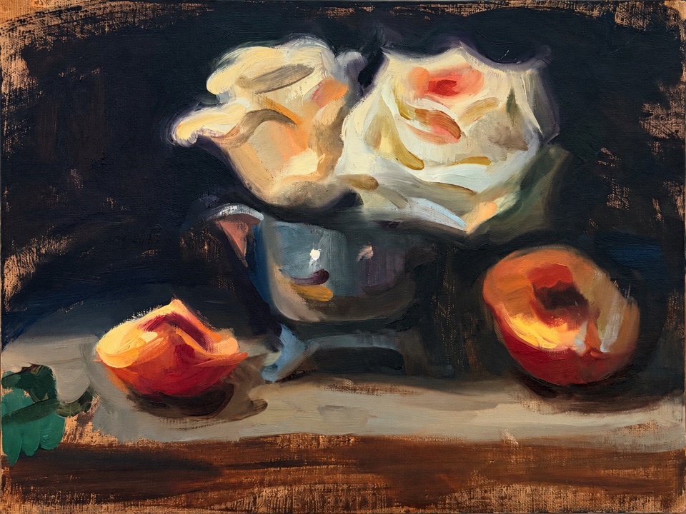 Pale roses in a metal vessel with cut fruit